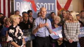 Governor Rick Scott, who is campaigning to replace U.S. Senator Bill Nelson, addressed his supporters Thursday alongside his wife Ann (left) and Attorney General Pam Bondi (right).