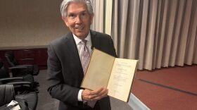 New Mexico Republican gubernatorial candidate Duke Rodriguez presents a printed copy of the state Constitution that he carries in his backpack following the Albuquerque Journal’s March 25, 2026 town hall. (Joshua Bowling/Source NM)