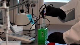 Above: a researcher at IU Indianapolis gives a demonstration during the opening of IU LAB. While research spending has grown on campus, its new research designation resulted from a change in Carnegie Classification standards.