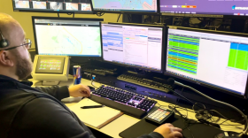 A call taker at the Dover 911 center uses video and text translation technology as part of upgrades to Delaware’s E911 services.