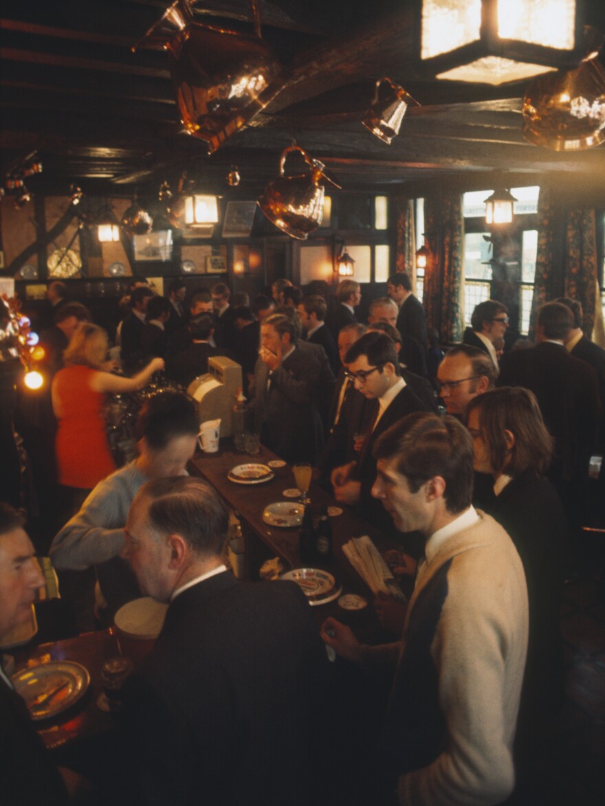 City workers meet and have a lunchtime pint at the bar in the Ye Olde Watling public house in London circa 1970.