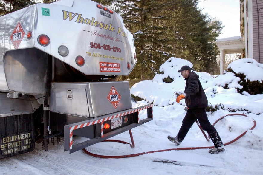 FILE: Jason Kilpatrick of Wholesale Fuel heads back to his truck after making a delivery of home heating oil in Framingham, Mass. Of Connecticut’s $80 million annual LIHEAP allocation, 10% is administered retroactively, once the winter season ends.
