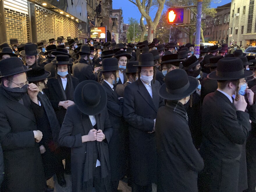 Hundreds of mourners gather in Brooklyn on April 28, to observe a funeral for Rabbi Chaim Mertz, a Hasidic Orthodox leader whose death was reportedly tied to the coronavirus. Mayor Bill de Blasio chastised "the Jewish community" following the breakup of the large funeral that flouted public health orders.
