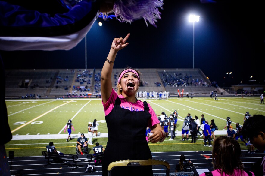 A band member in the stands of a football stadium