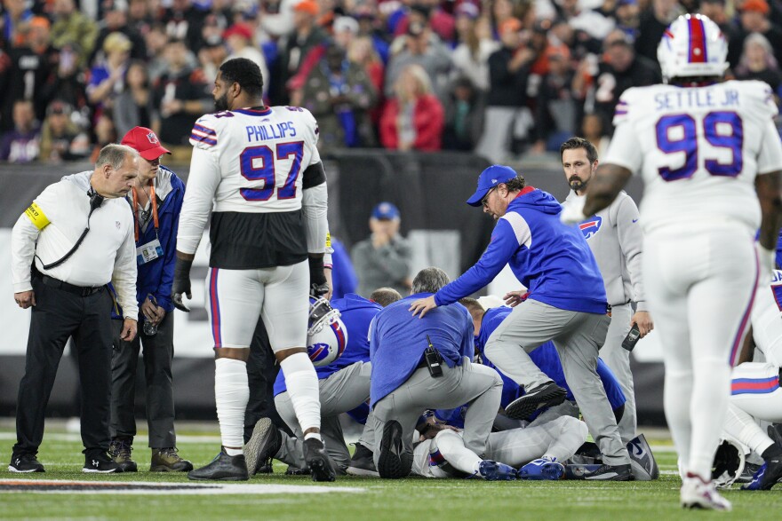 Damar Hamlin is examined during the first half of an NFL football game against the Cincinnati Bengals, Monday, Jan. 2, 2023, in Cincinnati. (AP Photo/Jeff Dean)