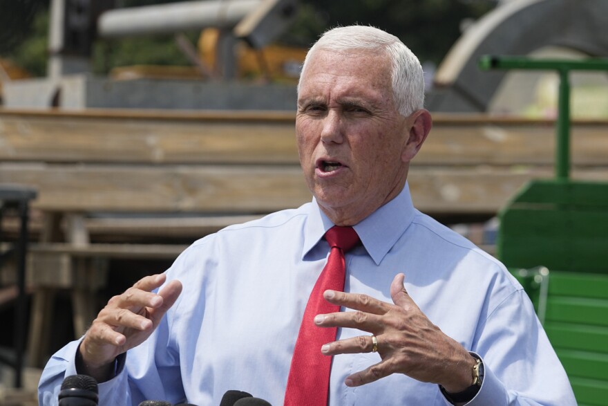 FILE - Republican presidential candidate and former Vice President Mike Pence speaks with the media during a stop at the Indiana State Fair, Aug. 2, 2023, in Indianapolis. Pence announced Tuesday he has qualified for the first Republican debate of the 2024 presidential cycle, securing the required number of donors with just two weeks until candidates gather in Milwaukee.