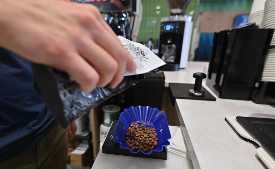 Kyle Mervau measures coffee beans to make a pour over at Electric City Roasting Co.