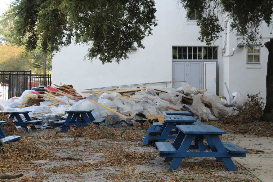 Piles of storm debris from Hurricane Ida sit in the courtyard at Frederick A. Douglass High School. Sept. 9, 2021.