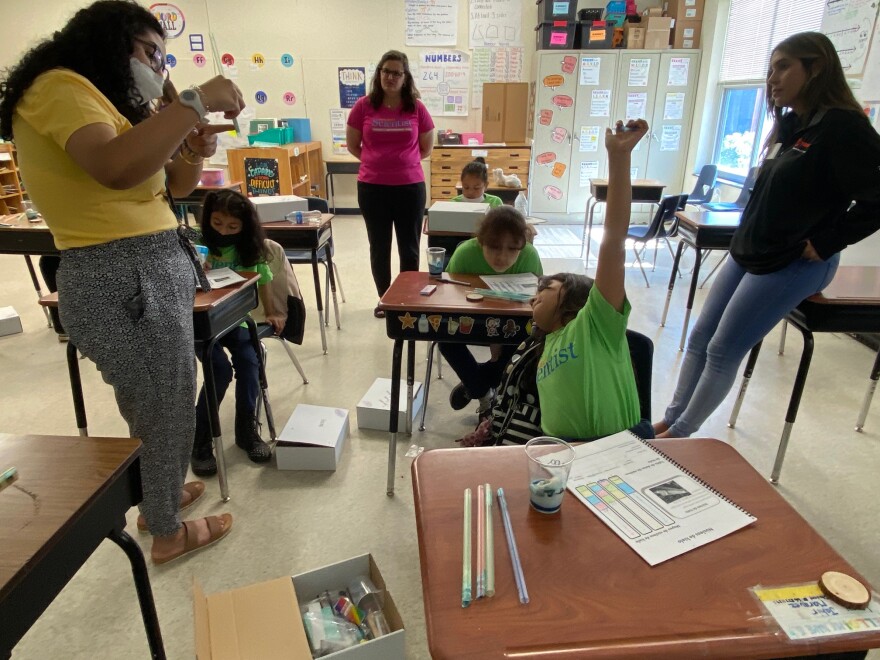 Teacher Zarett Ramirez (left) leads Spanish-speaking girls at Devonshire Elementary in an activity on icebergs and climate change.