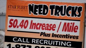 A sign from a trucking company in Nappanee, Indiana, recruits truckers. In some industries, like trucking, worker shortages were exacerbated by the pandemic.