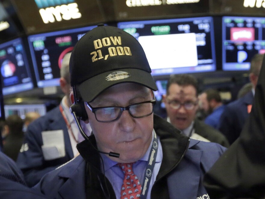Trader Richard Cohen wears a "Dow 21,000" cap as he works on the floor of the New York Stock Exchange on Wednesday.