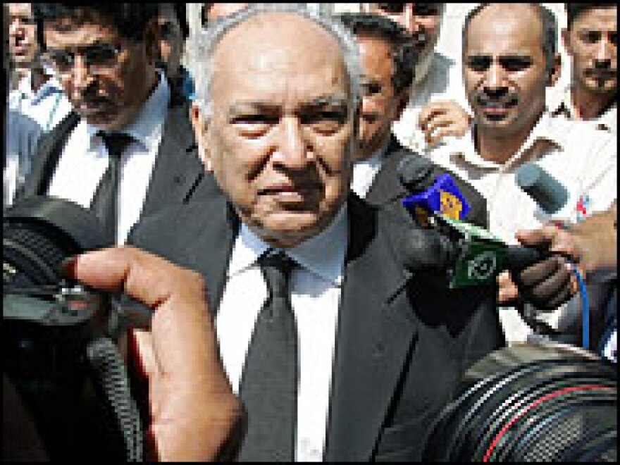 Sharfuddin Pirzada, lawyer for Pakistan President Gen. Pervez Musharraf, is surrounded by media representatives as he leaves the Supreme Court after a hearing in Islamabad, Pakistan, Tuesday.