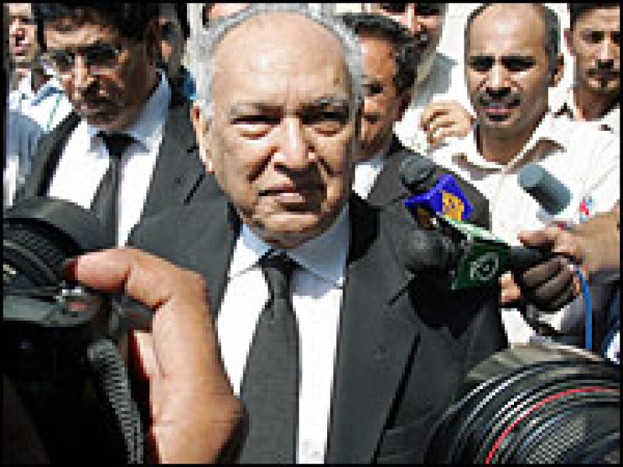 Sharfuddin Pirzada, lawyer for Pakistan President Gen. Pervez Musharraf, is surrounded by media representatives as he leaves the Supreme Court after a hearing in Islamabad, Pakistan, Tuesday.