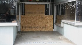 One of many empty storefronts is boarded up along a street in downtown Rocky Mount, N.C., Thursday, Dec. 18, 2025.