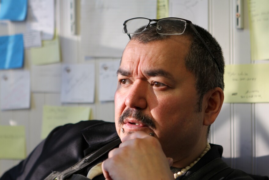 20191028-Leon-Missuk-Kinneeveauk-sitting-at-his-desk-overlooking-4th-Avenue-inside-the-Arctic-Treasures-gallery-and-workshop-he-owns.jpg