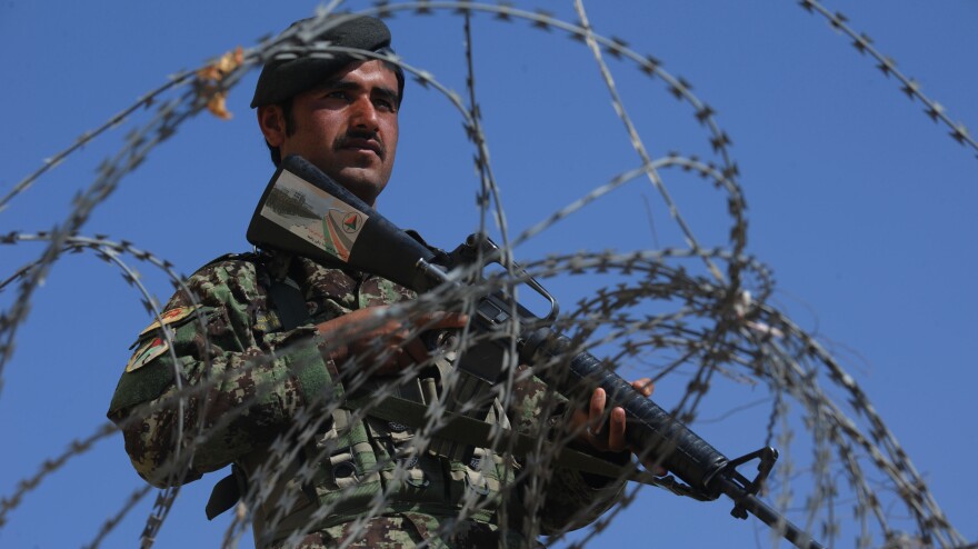 An Afghan soldier stands guard in the western city of Herat in October. U.S. Maj. Gen. James McConville, who commands coalition forces in eastern Afghanistan, says Afghan forces did hold their ground this year, but "they're not winning by enough that the enemy is willing to stop fighting yet."