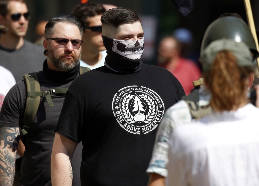 A white nationalist wearing a T-shirt with the Rise Above Movement logo attends the gun rights rally on Saturday. Rise Above Movement is a white supremacist group based in Southern California.