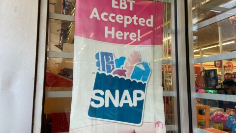 A sign shows electronic benefit transfer (EBT) cards used for SNAP benefits is accepted at a store in Columbus.