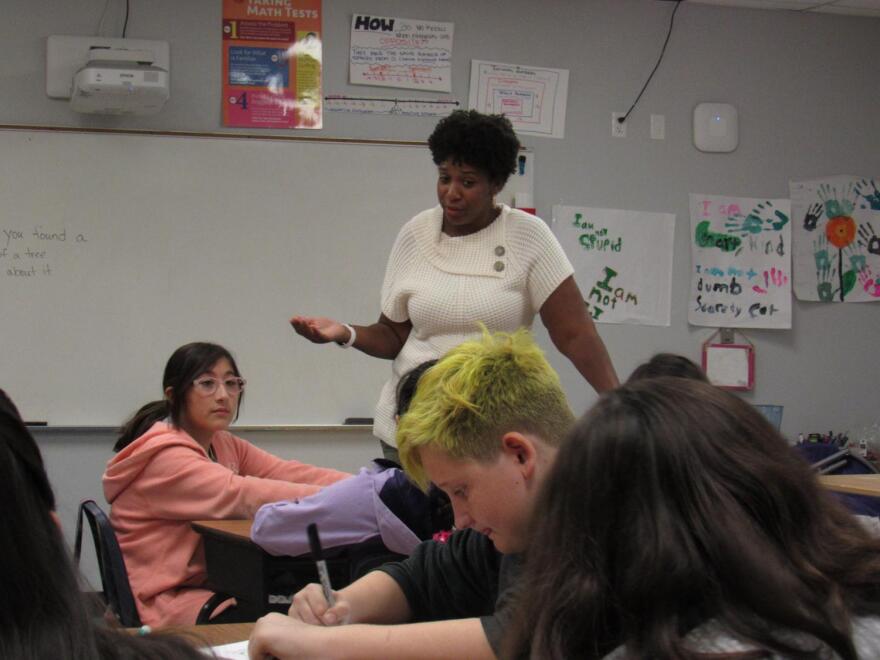 Teacher Angela Patton talks with students about a creative writing assignment at Esperanza Prep in Tempe.