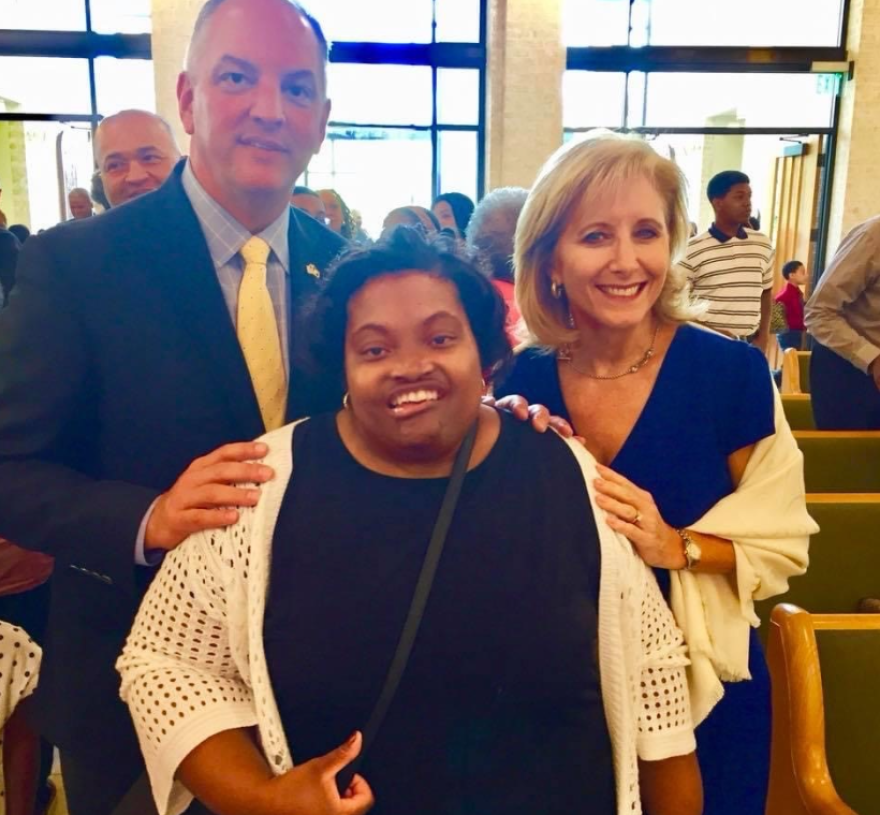 Disability rights activist April Dunn alongside former Gov. John Bel Edwards and his wife Donna Edwards