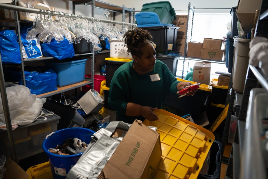 Marty Casey, the founder of the UnGUN Institute, sorts through bins of clothing and housing good donations at the center’s headquarters on Tuesday, Nov. 4, 2025, in St. Louis’ Hamilton Heights neighborhood.