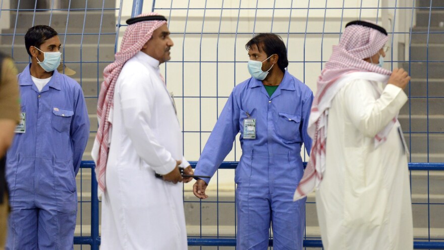 Fearful of catching the MERS virus, workers wear masks during a soccer match on April 22 at  King Fahad stadium in Riyadh.