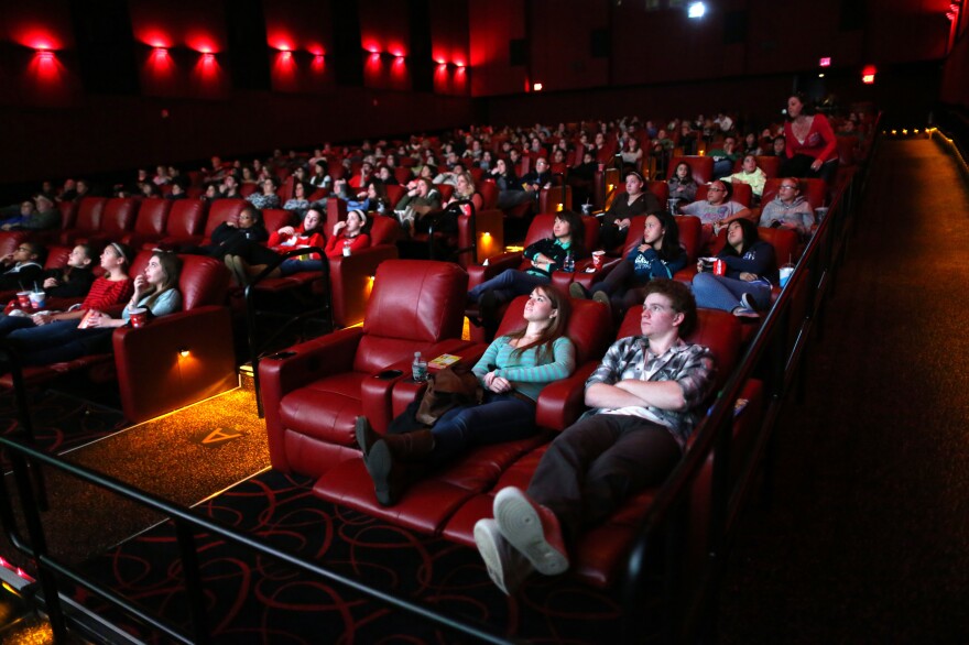 Moviegoers relax in recliner seats at AMC Movie Theater in Braintree, Mass., in 2013.