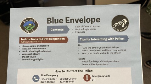 A picture of one side of the official envelope of Boulder Police's Blue Envelope Program. It has instructions for police and first responders to interact with people who may have an unseen disability.
