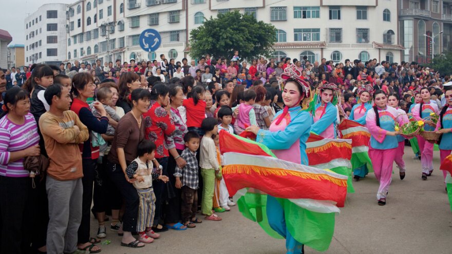 Dancers in boat costumes whirl as part of the parade celebrating Mazu on Meizhou Island.