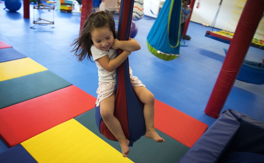 Isley Best, 4, rides a zipline on Sunday, October 1, 2017, at We Rock the Spectrum Kid's Gym in Bellevue. 