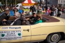 Couple rides in yellow convertible.