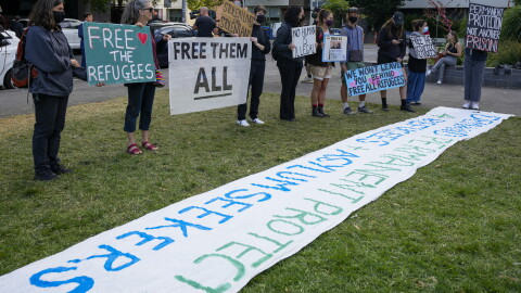 FILE - Refugee advocates stand outside the Park Hotel, used as an immigration detention hotel in Melbourne, Australia, Monday, Jan. 10, 2022.
