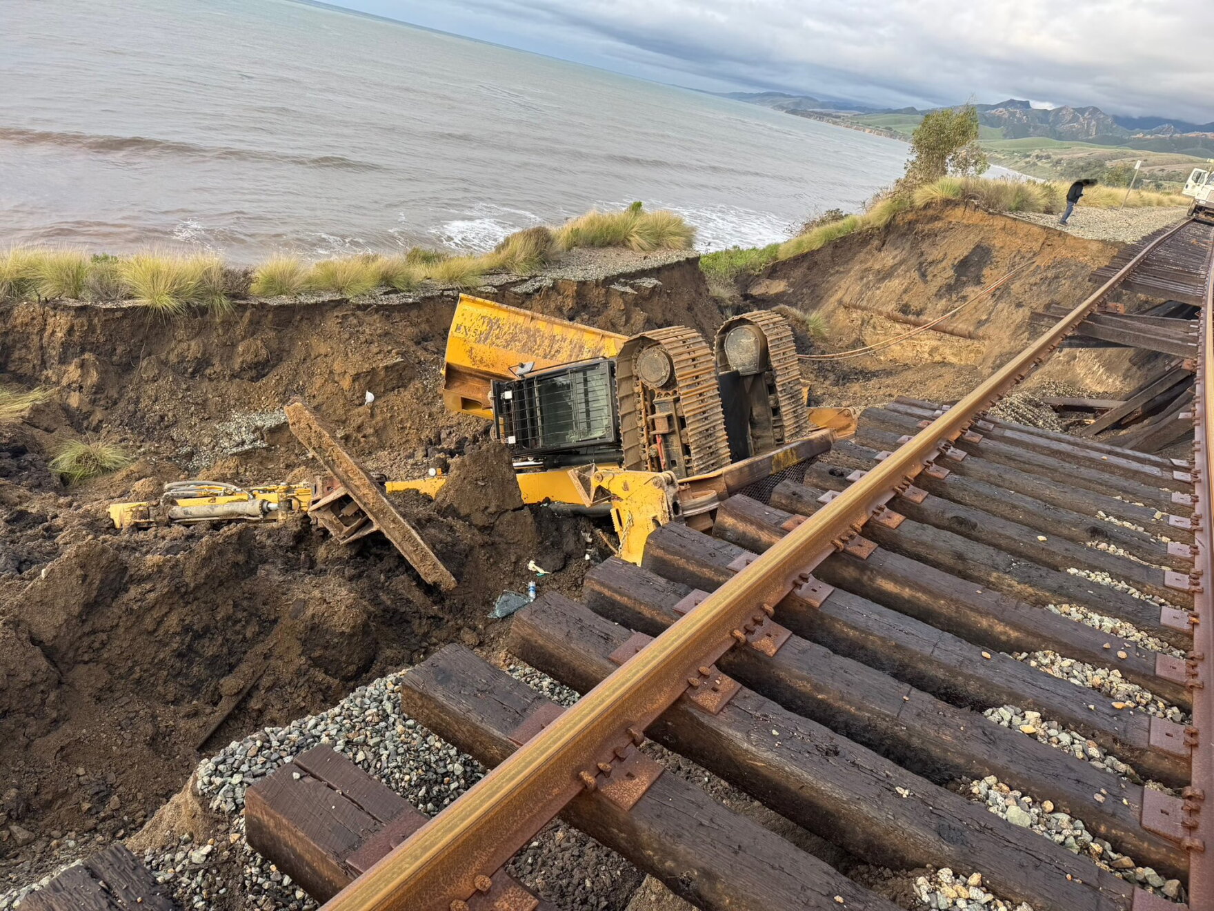 Excavator operator injured when storm-damaged rail line collapses on ...