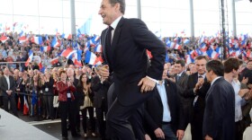 France's incumbent President Nicolas Sarkozy arrives on stage to deliver a speech during a campaign meeting in Cernay, eastern France, on April 25, 2012. Sarkozy will face his rival Socialist Party Francois Hollande in a final round on May 6, 2012.