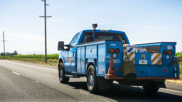 A PG&E service vehicle driving on the freeway