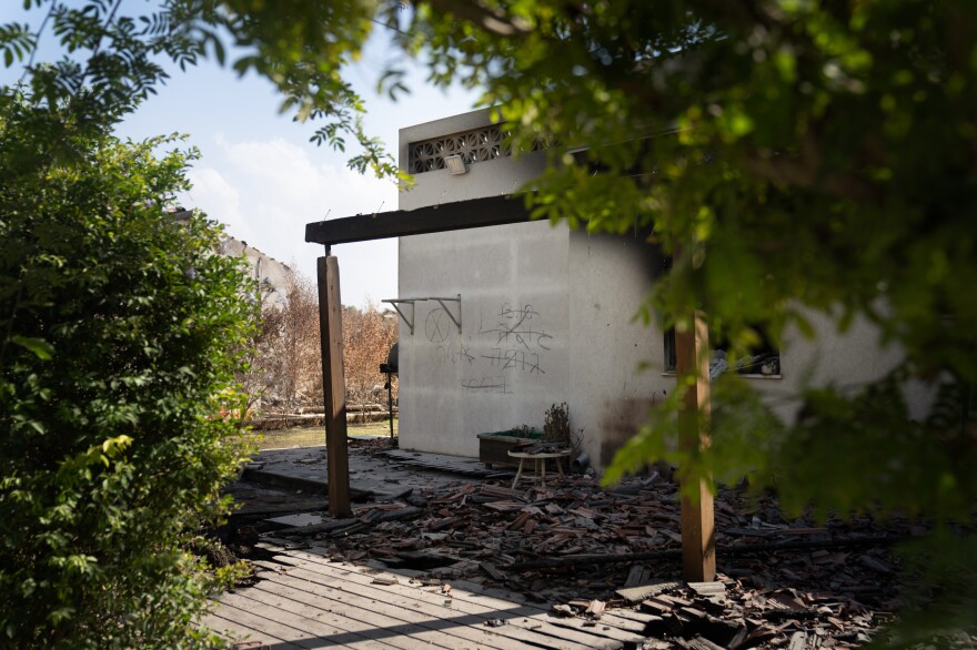 An Israeli search and recovery team marked the wall of a house in Kibbutz Be'eri with the number of bodies they found.