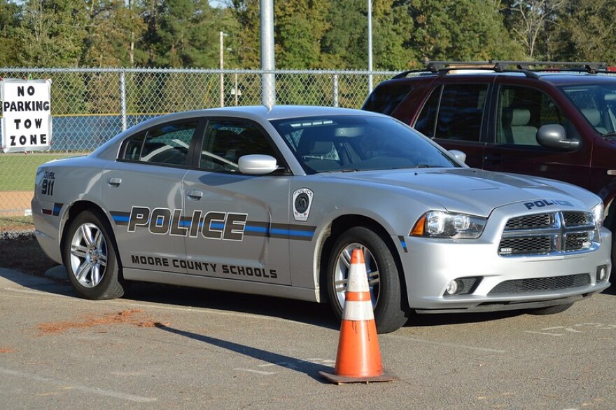 Squad car that reads "Police, Moore County Schools."