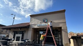 A crew from Reaching Solutions Sign Installation & Maintenance in Olathe installs signage for the Kansas City Current's new retail shop on the Country Club Plaza. The illuminated channel letter sign was fabricated by Midtown Signs in Kansas City, Kansas.