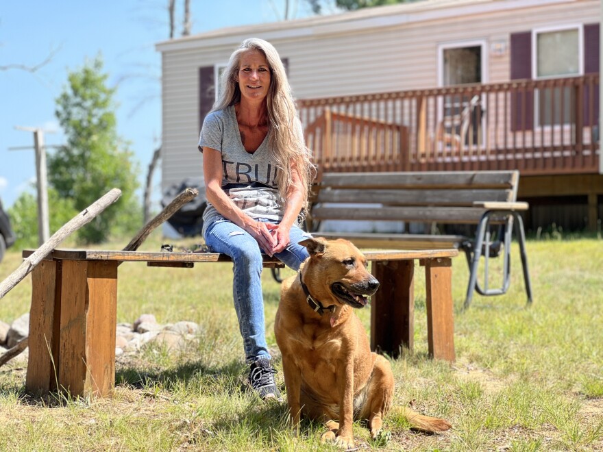 Debbie Light relaxes with her dog Lexi on her family’s property off Portage Creek Road, Aug. 16