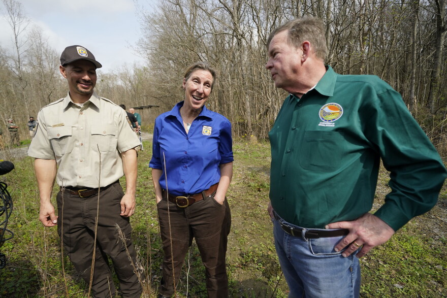 FILE - Martha Williams Director of the U.S. Fish and Wildlife Service, center, talks with Jimmy Laurent, regional energy coordinator for U.S. Fish and Wildlife, left, and Thomas Harris, Secretary for the Louisiana Department of Natural Resources, as they visit the B-5 orphan well site in the Atchafalaya National Wildlife Refuge in Lottie, La., Thursday, Feb. 16, 2023. Dozens of scientists from universities across the nation are challenging whether Williams has the education needed to run an agency in charge of managing endangered species. (AP Photo/Gerald Herbert, File)
