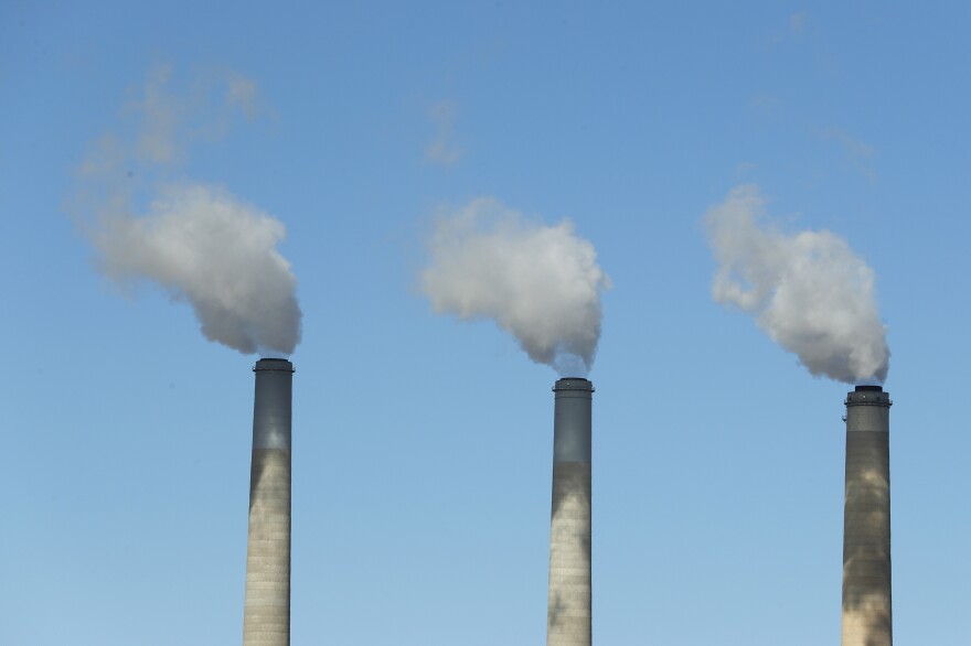 Emissions rise from three large smokestacks at a coal-fired power plant in Castle Dale, Utah, in 2017. Democratic presidential candidates are releasing plans to reduce U.S. emissions in order to head off the most dangerous consequences of global warming.