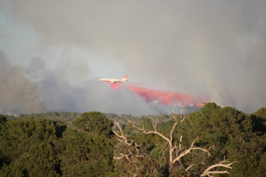 A tanker plane drops fire retardant on the Old Potato fire in Bastrop, that began October 4, 2011.