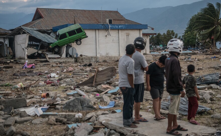 A car sits wedged into a building Monday, days after a tsunami struck the city of Palu, Indonesia, triggered by an earthquake. At least 1,200 people have been confirmed dead in the disaster.