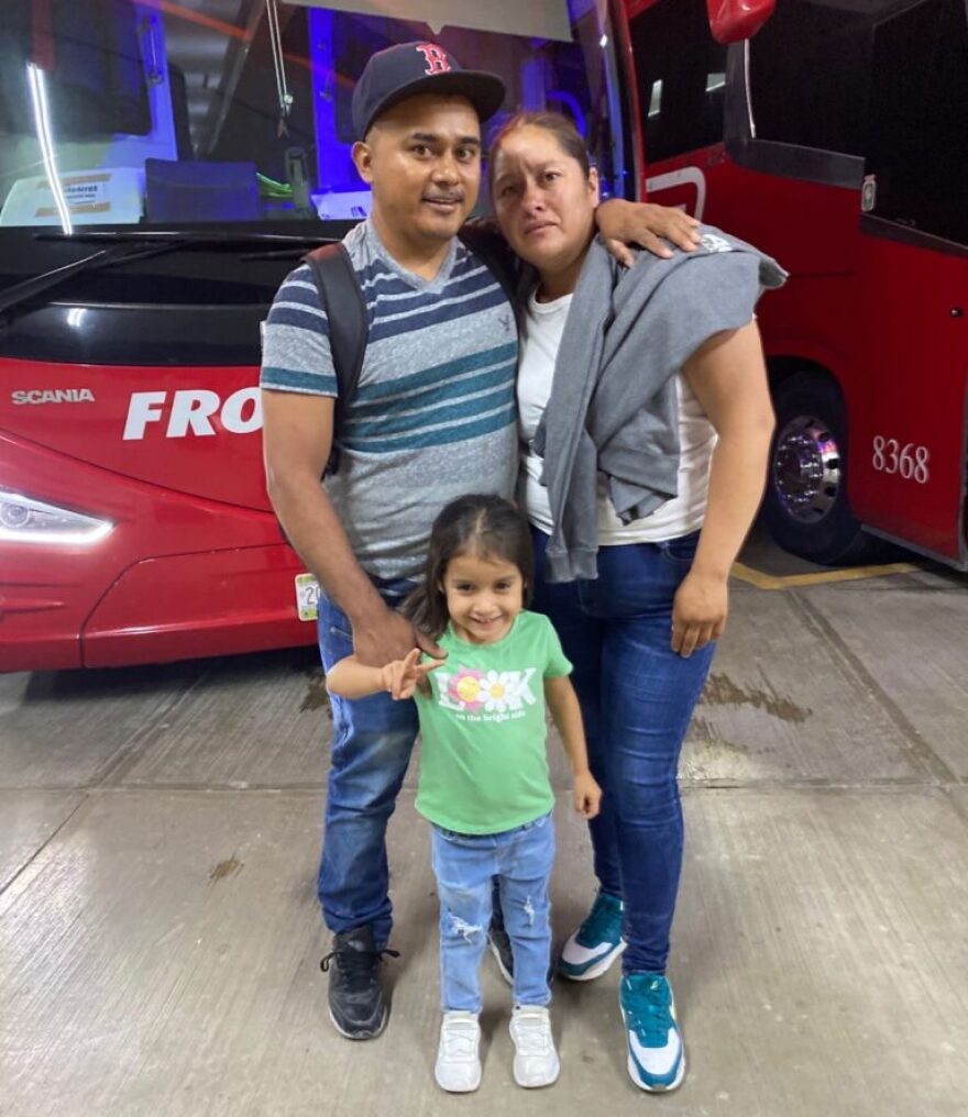 Marco Antonio Hernandez Guevara with his wife and youngest daughter, 4, before boarding the bus to work as an H-2A worker in the U.S. this summer.