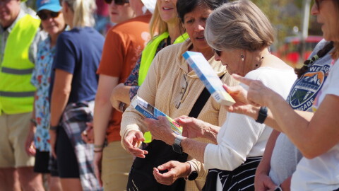 Members of the Kimball Junction library book brigade pass books to one another Oct. 3, 2026.