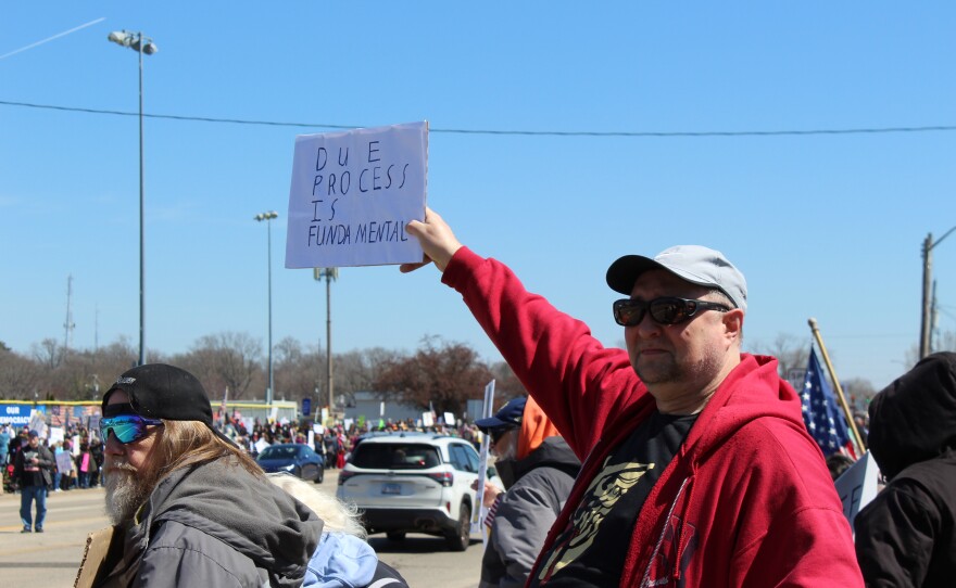 Karl Houck holds a sign reading "Due Process is Fundamental 