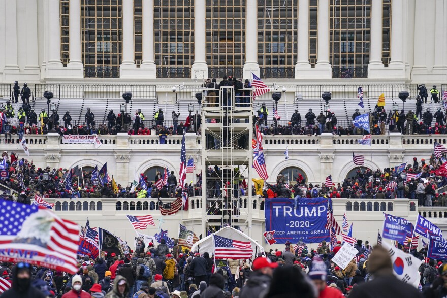 FILE - Insurrectionists loyal to President Donald Trump breach the Capitol in Washington, Jan. 6, 2021. The founder of the Hawaii Proud Boys chapter and another man who stormed the Capitol on Jan. 6, 2021, and posed for a picture in front of a door one of them inked with the words “Murder the Media” have admitted to a felony charge in the riot. Nicholas Ochs, the founder of the group’s Hawaii chapter, and Nicholas DeCarlo, of Fort Worth, Texas pleaded guilty on Friday, Sept. 9, 2022, to obstructing the certification of President Joe Biden’s Electoral College victory. (AP Photo/John Minchillo, File)