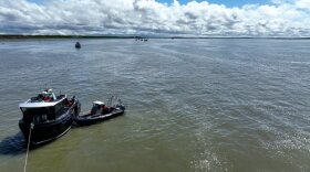 An Alaska Wildlife Trooper boards a commercial fishing vessel in Bristol Bay from an AWT patrol skiff.