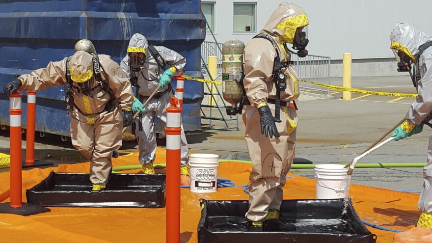 Members of the Royal Canadian Mounted Police go through a decontamination procedure after intercepting a package containing around 1 kilogram (2.2 pounds) of the powerful opioid carfentanil, imported from China to Vancouver. China has now added the drug to its list of controlled substances.