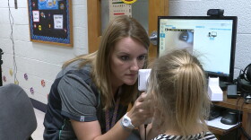 A school nurse uses telemedicine equipment to examine a student. (Brock Turner, WTIU/WFIU News)